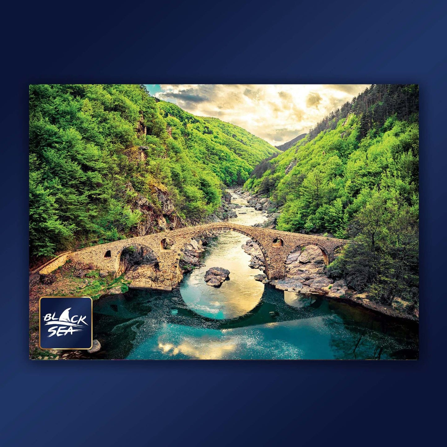 Puzzle Black Sea Premium 1000 pieces - Devil’s Bridge, The Devil’s Bridge that crosses Arda River in the vicinity of the town of Ardino is amazing not only because of its construction, but with the mysterious legends associated with it too. It is one of t