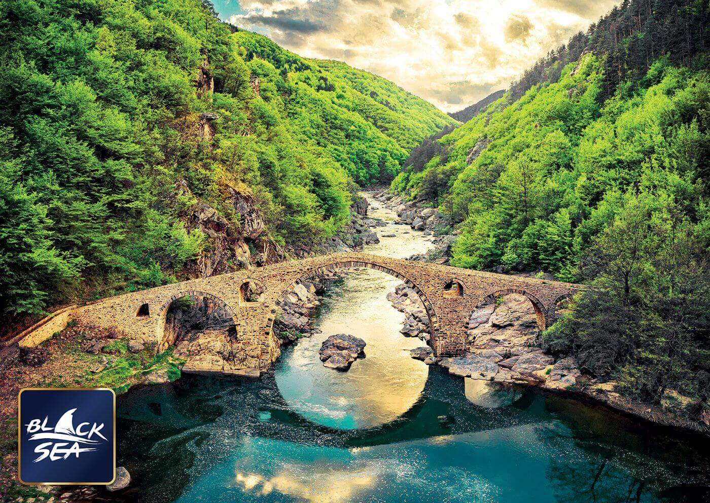 Puzzle Black Sea Premium 1000 pieces - Devil’s Bridge, The Devil’s Bridge that crosses Arda River in the vicinity of the town of Ardino is amazing not only because of its construction, but with the mysterious legends associated with it too. It is one of t